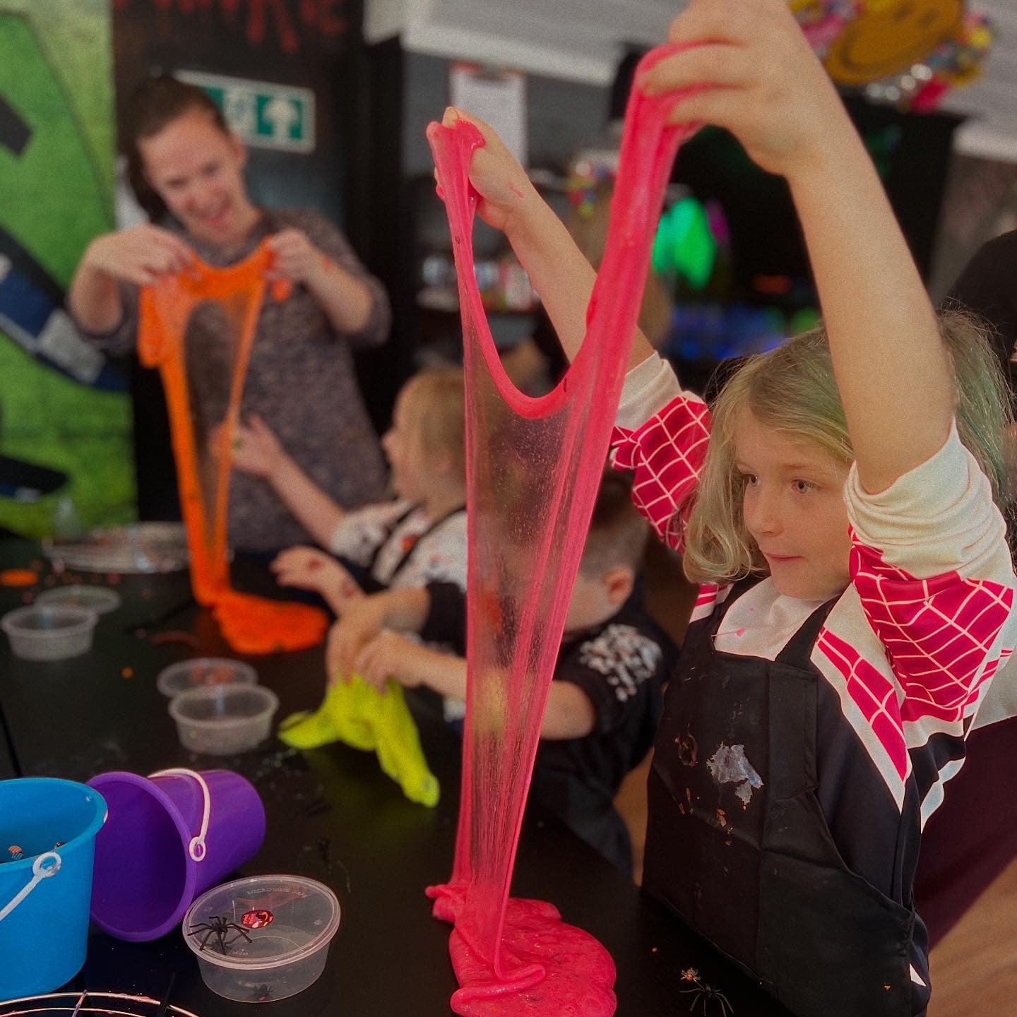Child holding up pink slime at art-ful Worthing