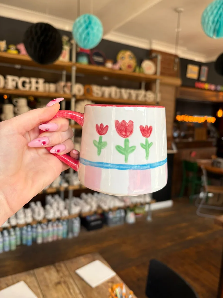 Hand-painted tulip mug at art-ful pottery café Worthing